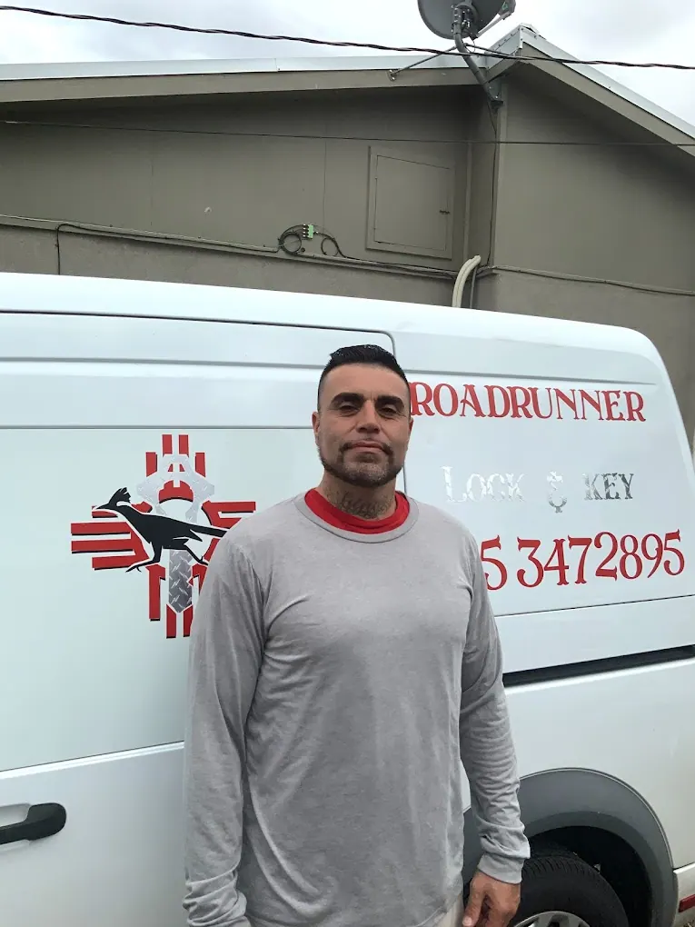 Genaro Vasquez, owner of Roadrunner Lock and Key, standing in front of a company van